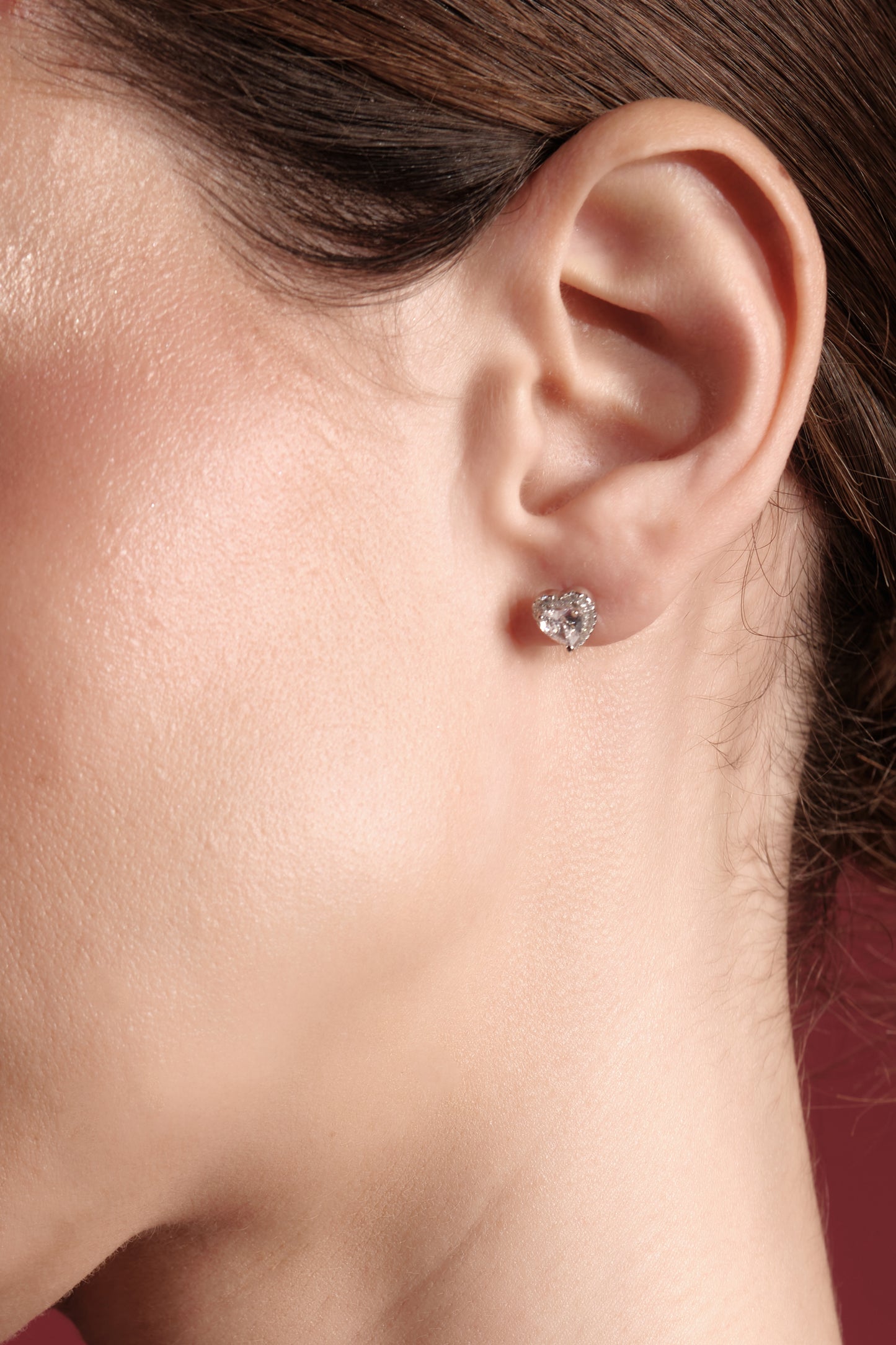 Close-up of La Petite Coeur — 925 sterling silver heart CZ stud earring with pavé halo