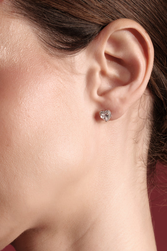 Close-up of La Petite Coeur — 925 sterling silver heart CZ stud earring with pavé halo