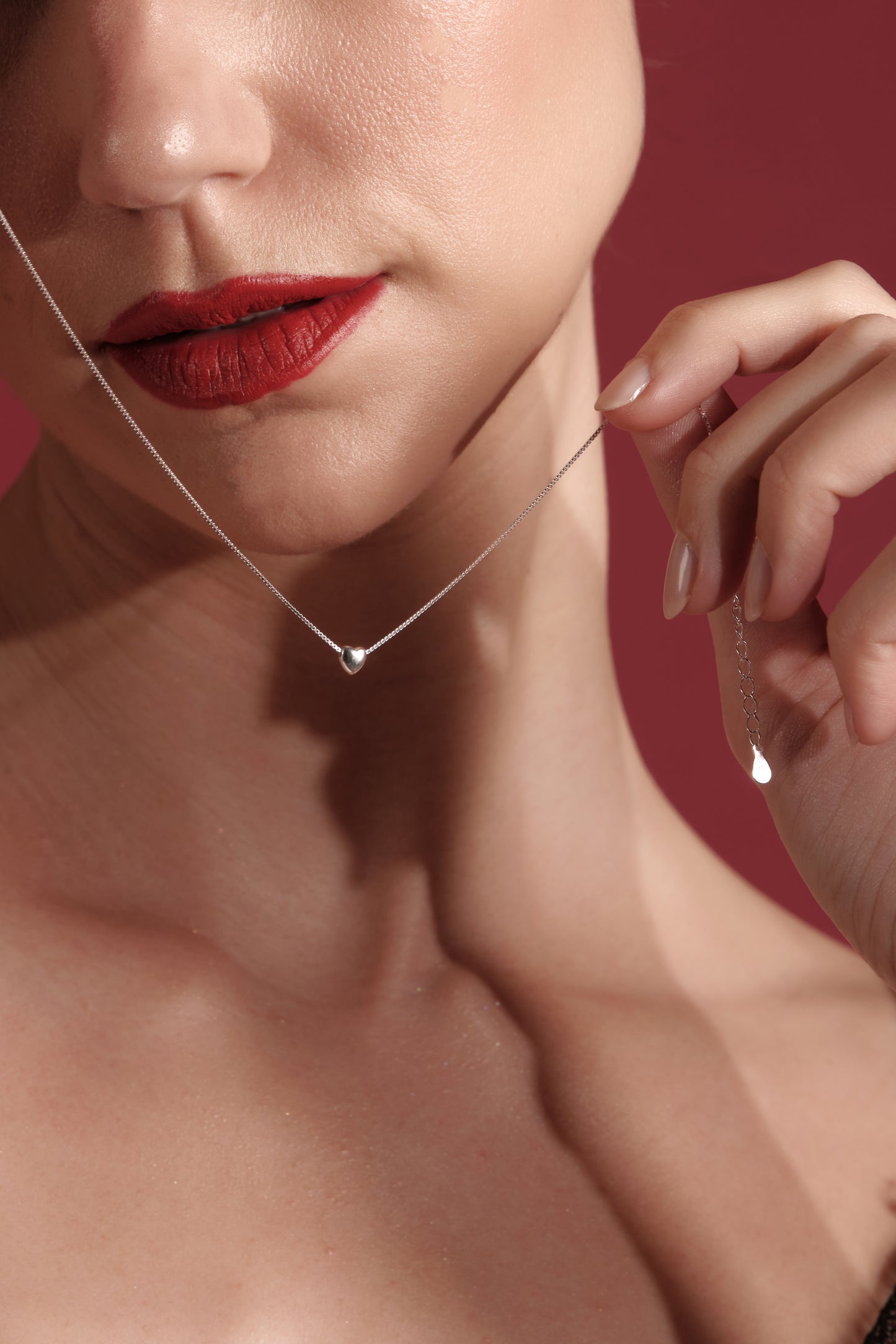 Close-up of 925 sterling silver necklace with tiny polished heart pendant on 45cm chain — Valentines jewelry