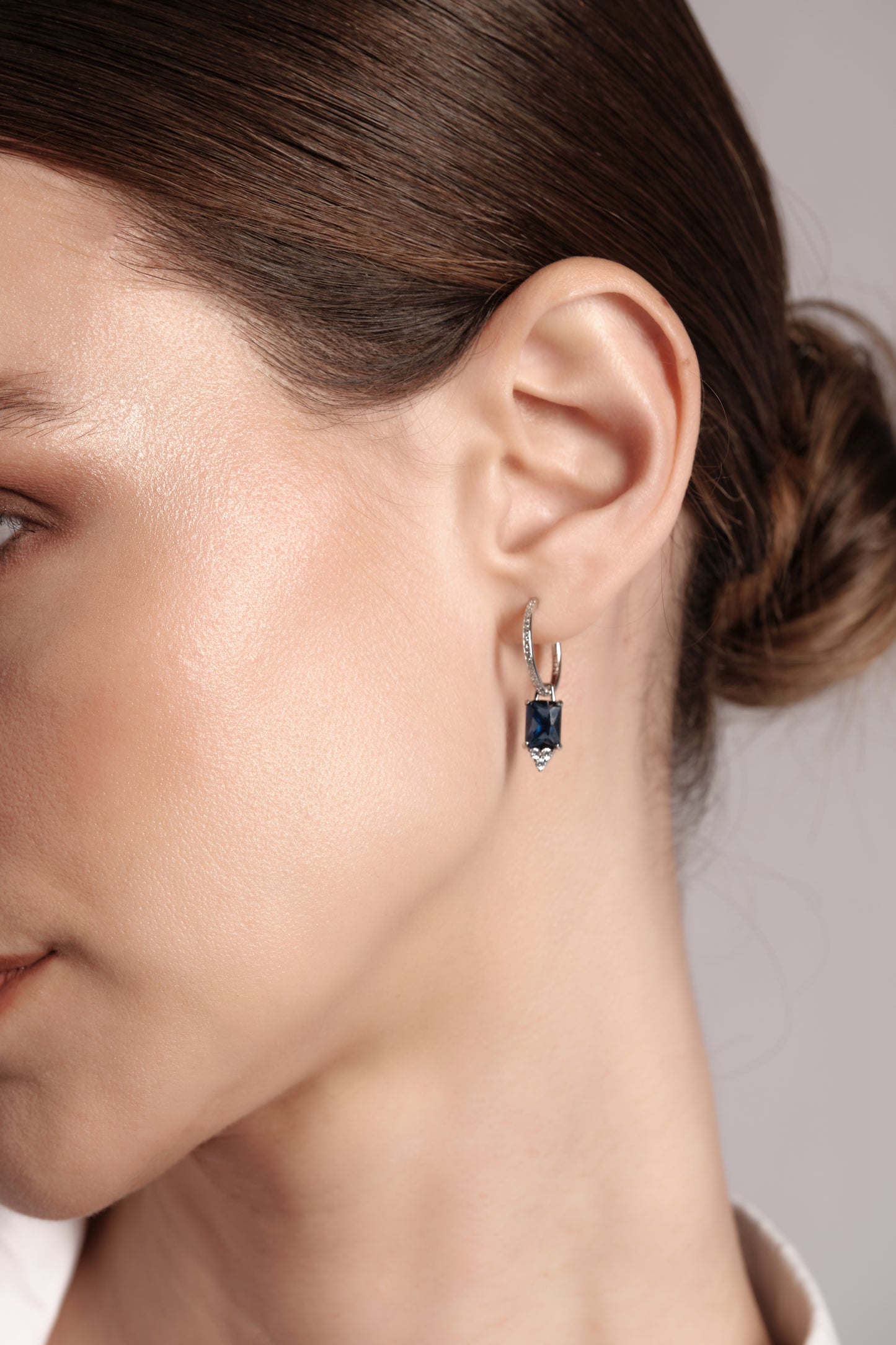 Close‑up of Sonnet of Blue 925 sterling silver earrings — rectangular blue drop stone with pavé hoop